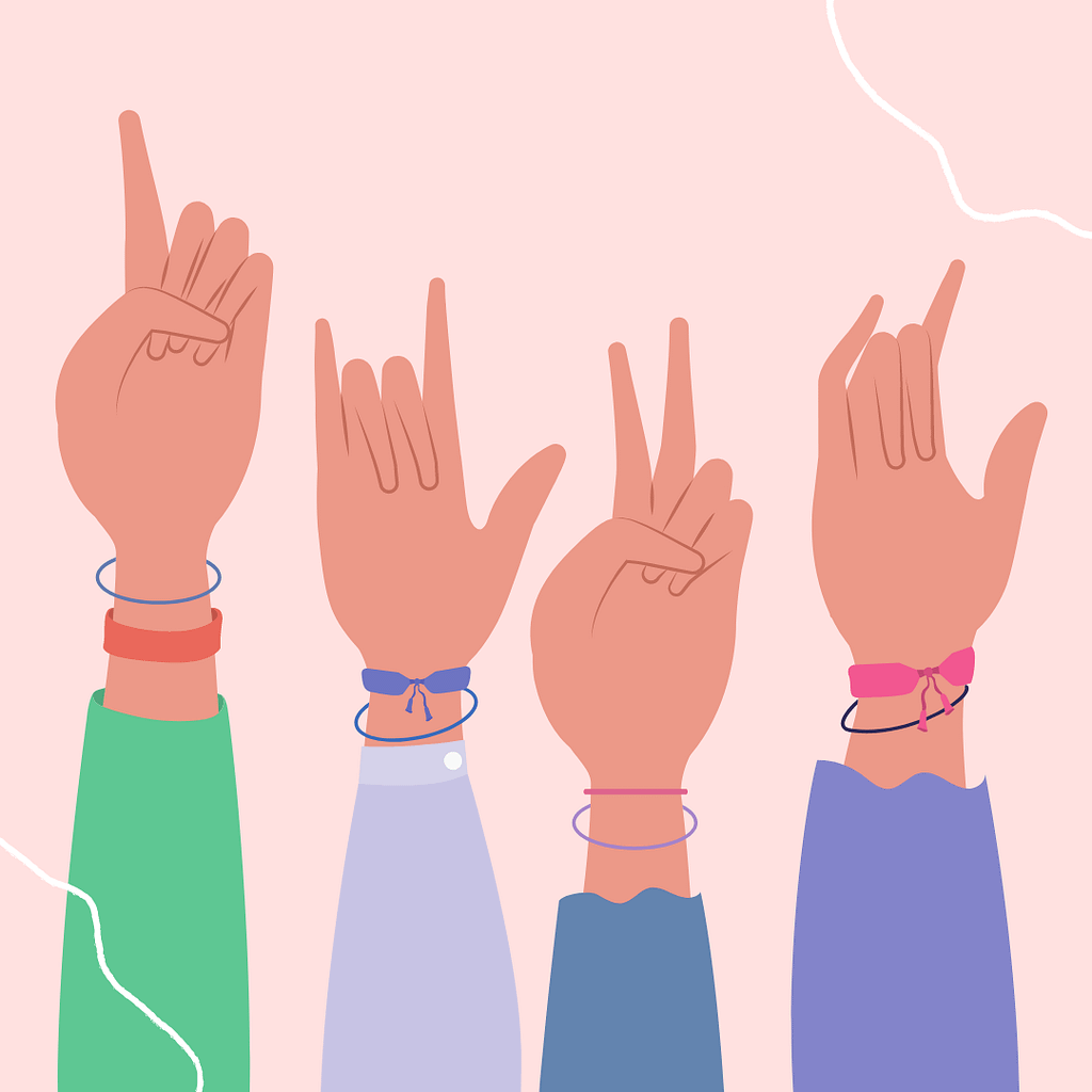 4 hands using sign language, arm sleeves of different colors.  